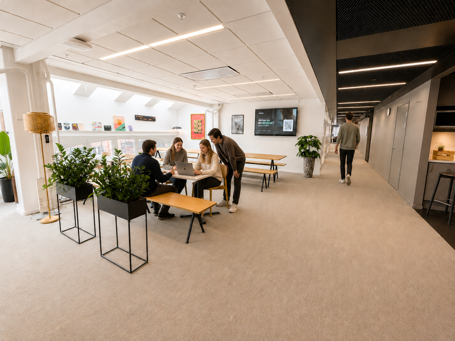 eAktiebok colleagues collaborating around a digital share register in the office's bright meeting area in Malmö